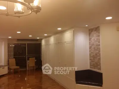 Spacious living room with elegant lighting and parquet flooring