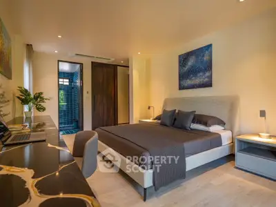 Luxurious bedroom with modern decor and ensuite bathroom, featuring a stylish workspace.