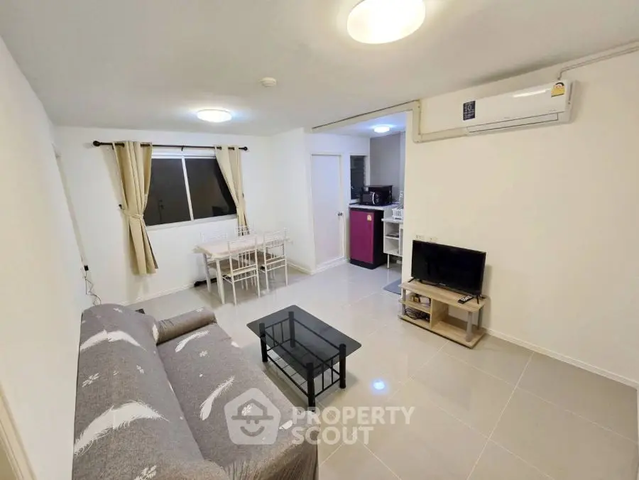 Modern living room with sleek furniture and air conditioning in a cozy apartment.