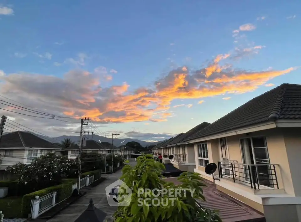 Charming suburban neighborhood with modern townhouses and stunning sunset view.