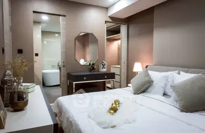 Luxurious bedroom with ensuite bathroom and walk-in closet, featuring elegant decor and ambient lighting.