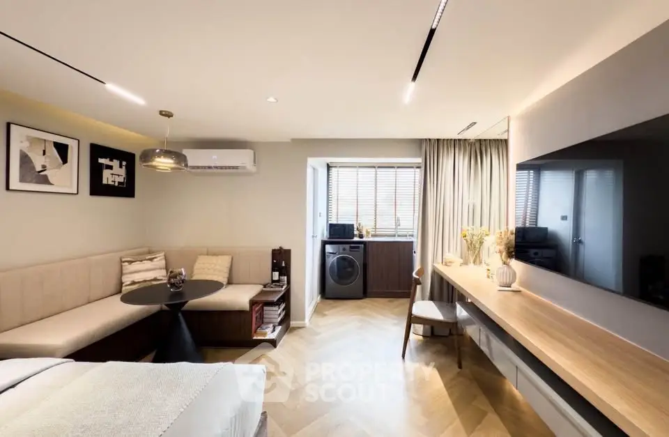 Modern studio apartment with stylish decor and in-unit washing machine