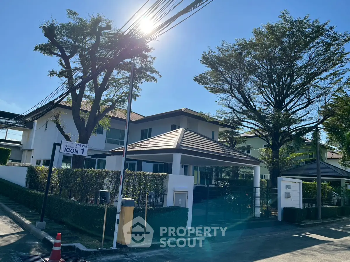 Modern residential building with lush greenery and clear blue sky