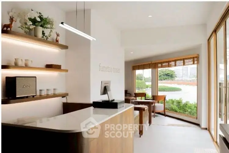 Modern reception area with sleek design and large windows offering scenic views.