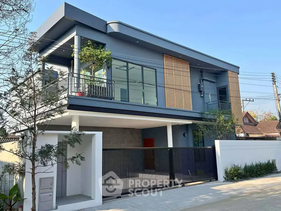 Modern two-story house with sleek design and spacious balcony in a serene neighborhood.