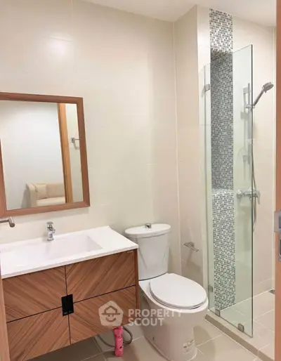 Modern bathroom with sleek vanity and glass shower enclosure