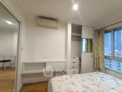 Cozy bedroom with built-in wardrobe and city view, perfect for urban living.