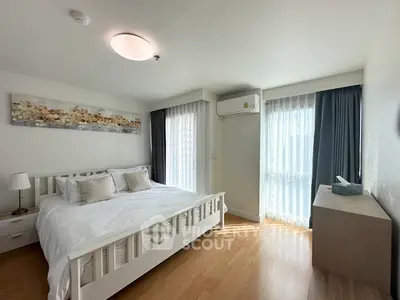 Bright and airy bedroom with modern decor and large windows in a stylish apartment.