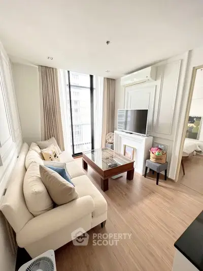 Elegant living room with modern decor and large windows in a stylish apartment.
