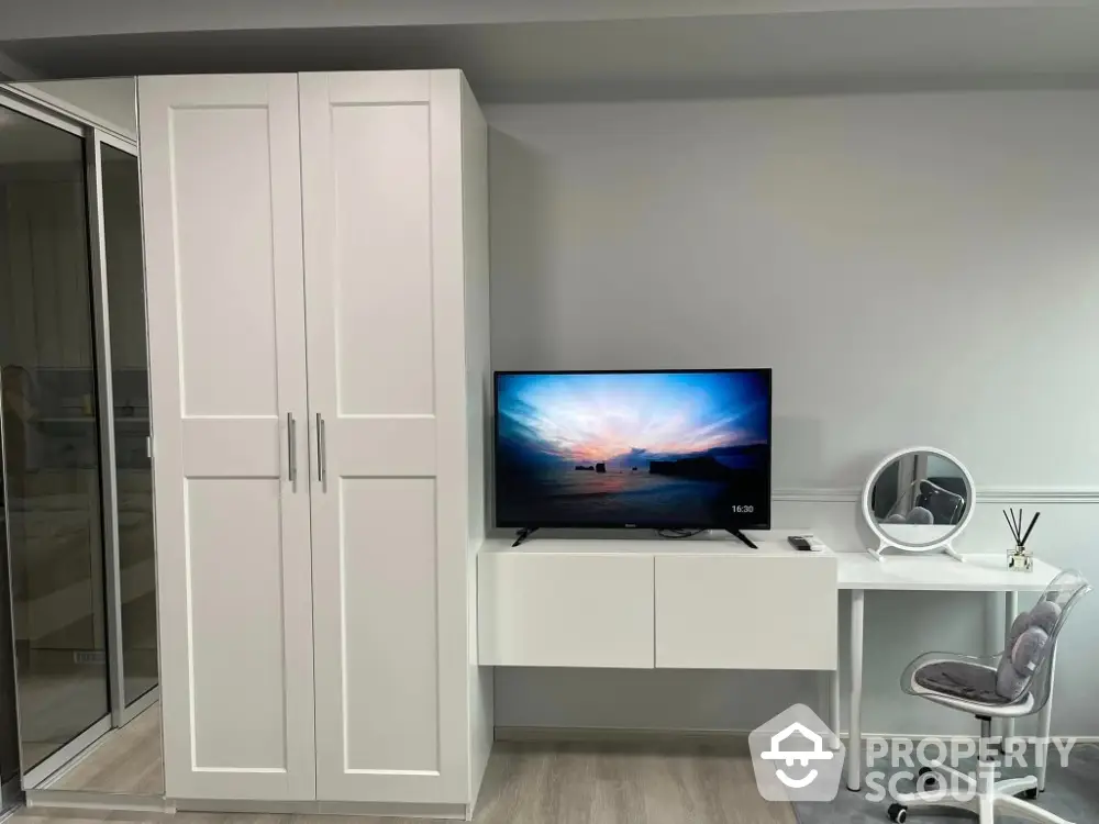 Modern bedroom with sleek white wardrobe and stylish desk setup