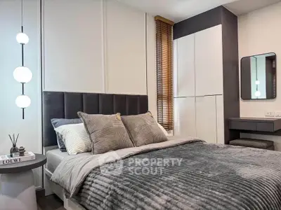 Modern bedroom with stylish decor and cozy bedding in a contemporary apartment.