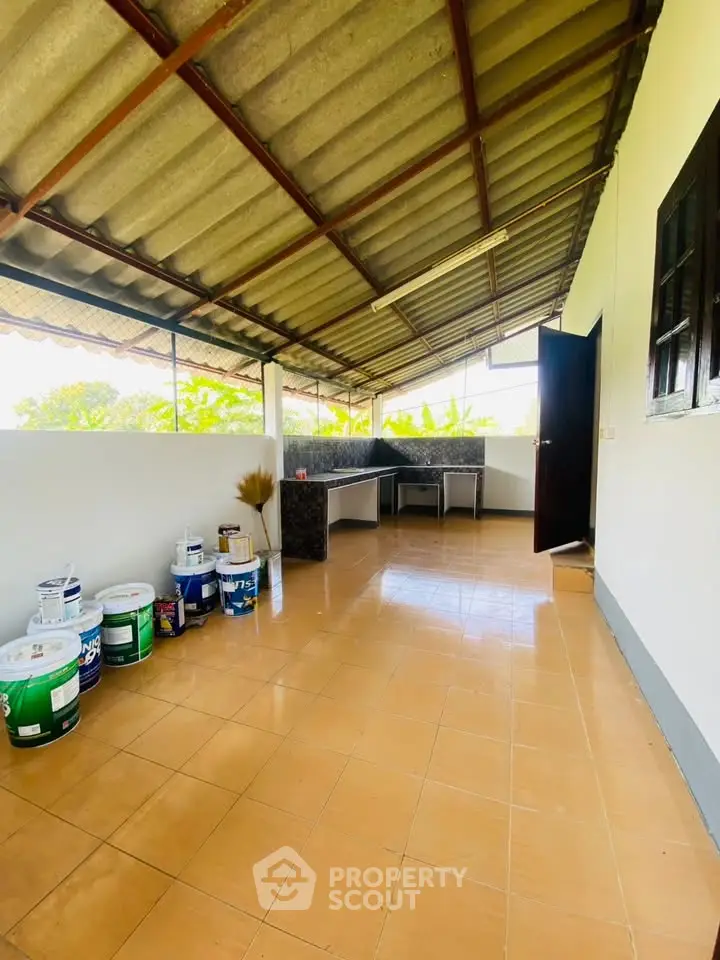 Spacious rooftop area with tiled flooring and open layout, perfect for outdoor activities.