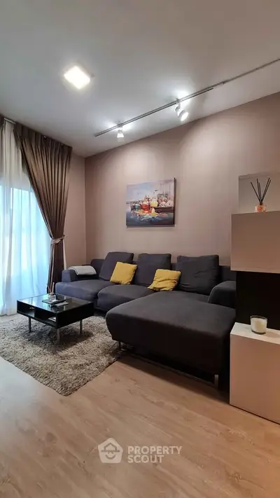 Modern living room with stylish decor and cozy seating area, perfect for relaxation.