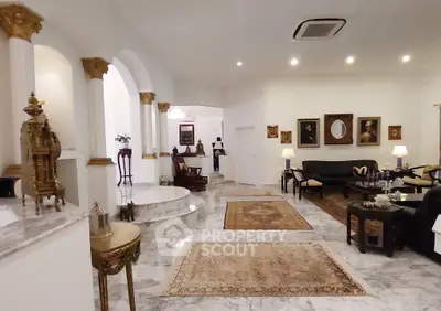 Luxurious living room with elegant decor, marble flooring, and classic furniture in a spacious open layout.