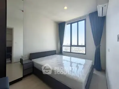 Modern bedroom with large window and city view, featuring sleek design and natural light.