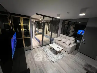 Modern living room with glass partition, cozy sofa, and stylish decor in a contemporary apartment.