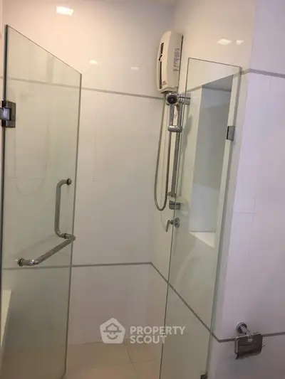 Modern bathroom with glass shower enclosure and sleek fixtures