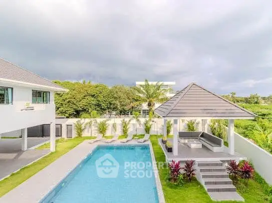 Luxurious villa with private pool and lush garden, perfect for relaxation and entertaining.