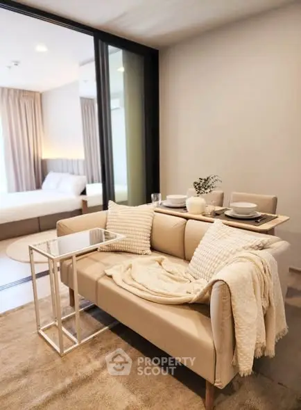 Stylish modern living room with cozy sofa and elegant dining setup