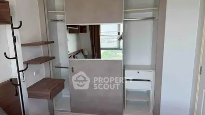Modern bedroom with built-in wardrobe and city view window