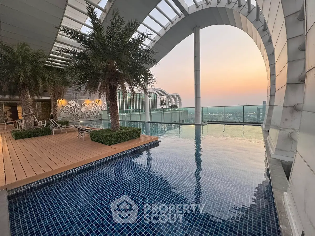 Luxurious rooftop pool with stunning sunset view and modern architecture.