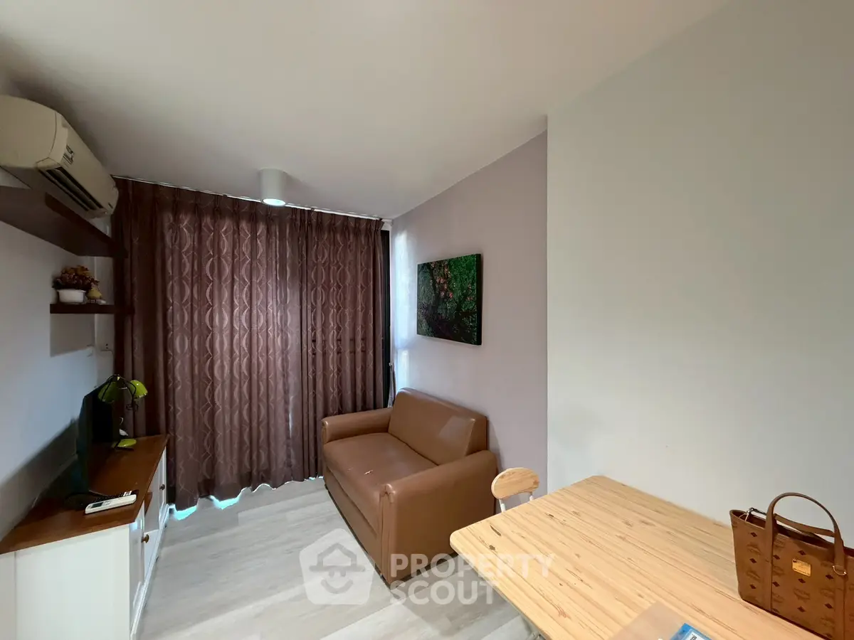 Cozy living room with brown sofa, wooden table, and elegant curtains in modern apartment.