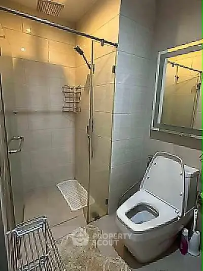 Modern bathroom with glass shower and sleek toilet design