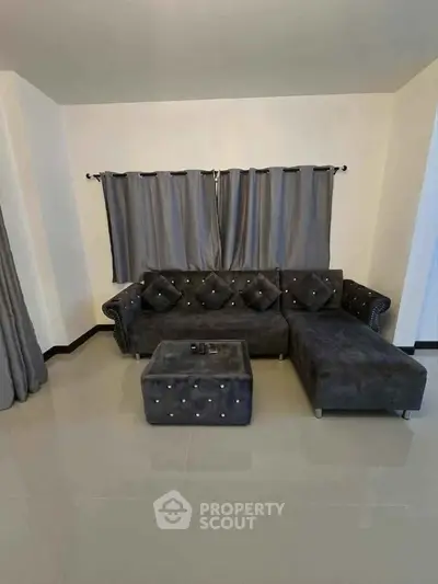 Stylish living room with plush gray sectional sofa and matching curtains