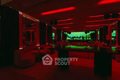 Luxurious modern lounge with ambient red lighting and sleek furnishings
