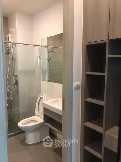 Modern bathroom with glass shower and sleek storage solutions