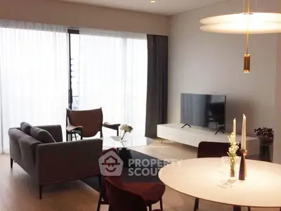 Modern living room with stylish furniture and large windows offering natural light.