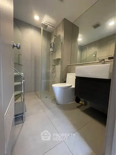Modern bathroom with sleek fixtures and glass shower enclosure