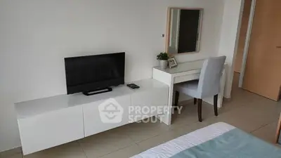 Modern bedroom with sleek furniture and TV setup