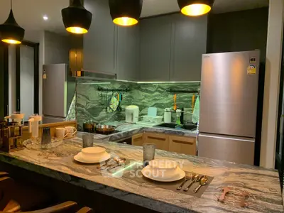 Modern kitchen with sleek appliances and elegant lighting