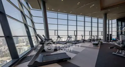 Luxurious high-rise gym with panoramic city views and modern equipment.