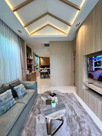 Luxurious modern living room with stylish decor and elegant ceiling design