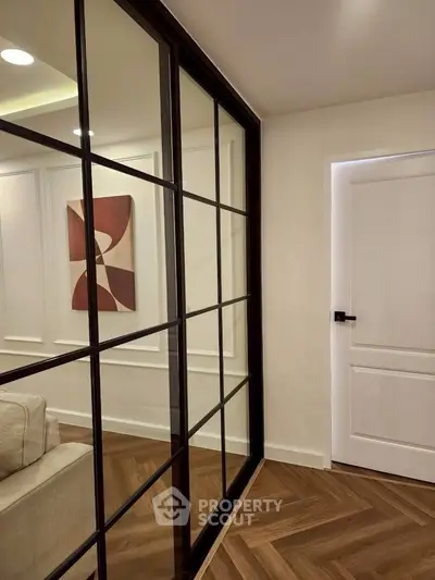 Modern interior with glass partition and elegant wood flooring