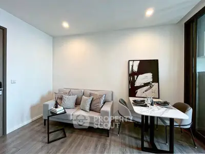 Modern living room with stylish decor and dining area, featuring a cozy sofa and elegant table setting.