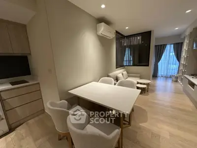 Modern living room with dining area and natural light