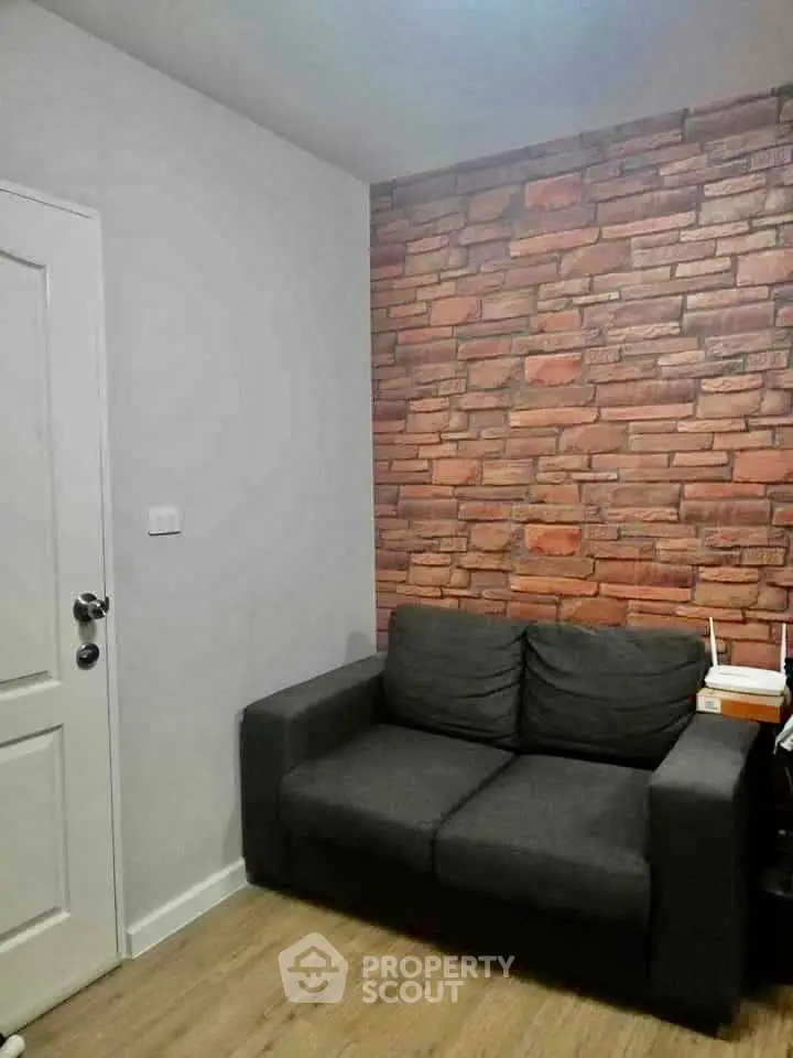 Cozy living room with stylish brick accent wall and modern sofa