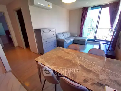 Modern living room with marble dining table and balcony view