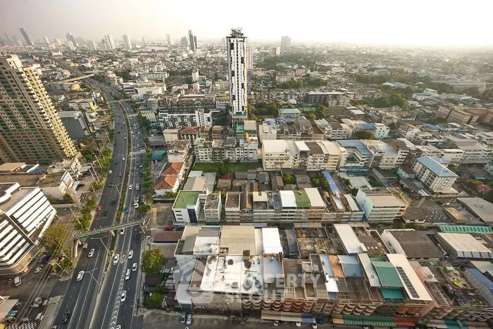 Stunning aerial view of urban cityscape with high-rise buildings and bustling streets, perfect for real estate investment.