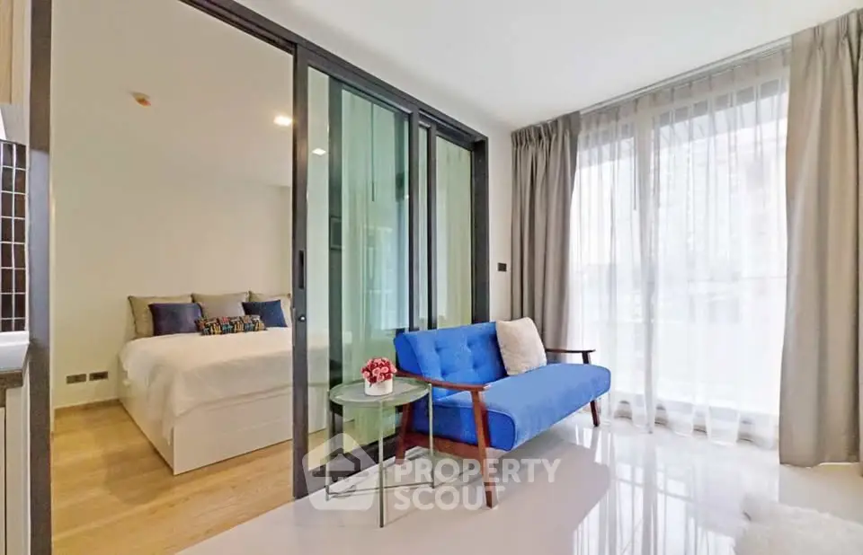 Modern apartment with glass partitioned bedroom and stylish living area