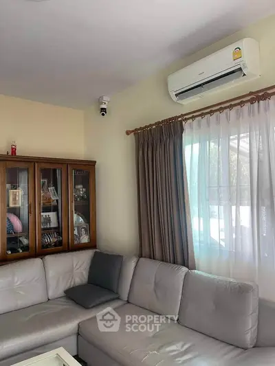 Cozy living room with modern air conditioning and elegant curtains