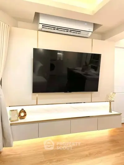 Modern living room with sleek TV setup and ambient lighting