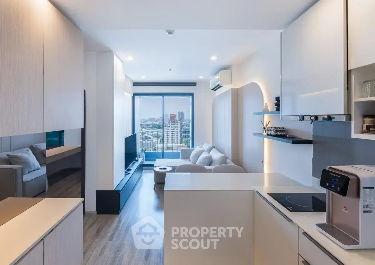 Modern open-layout living room with city view, sleek kitchen, and cozy seating area.