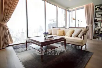Luxurious corner unit living room with panoramic city view and elegant decor.