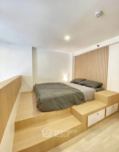 Modern minimalist bedroom with elevated platform bed and sleek design.