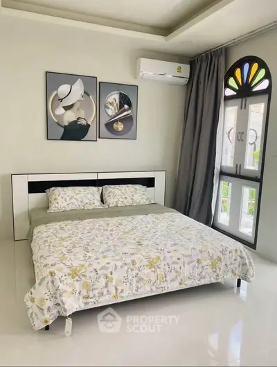 Modern bedroom with stylish decor and large window for natural light