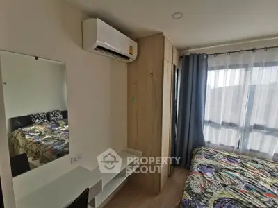 Modern bedroom with air conditioning and stylish decor in a well-lit apartment.